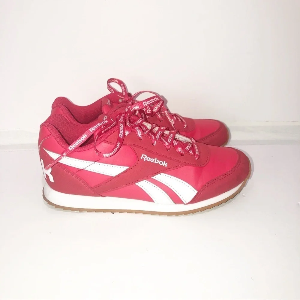 Reebok red classics with repeating logo strings.